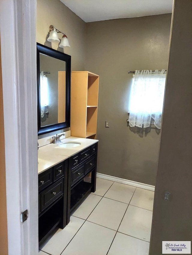 bathroom with tile patterned flooring and vanity