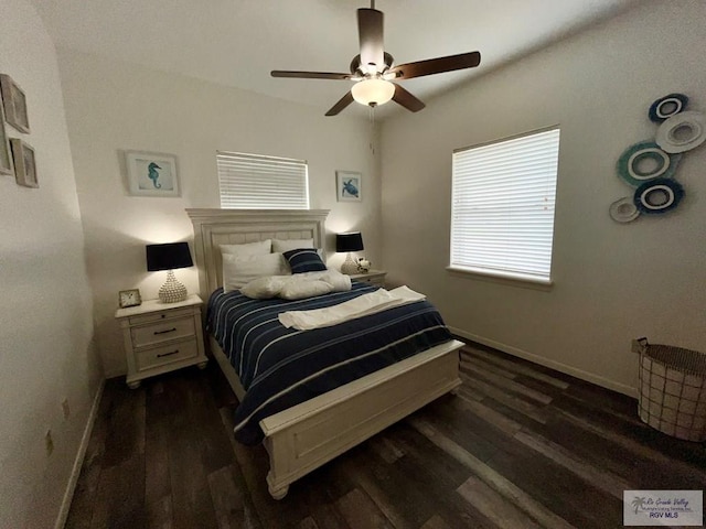 bedroom with a ceiling fan, baseboards, and dark wood-style floors