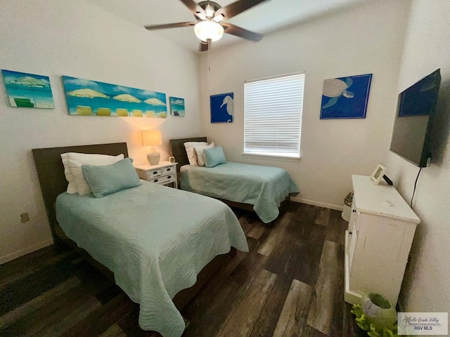 6410 Padre Blvd Unit 108, South Padre Island, TX 78597 - bedroom with dark wood-type flooring, baseboards, and a ceiling fan