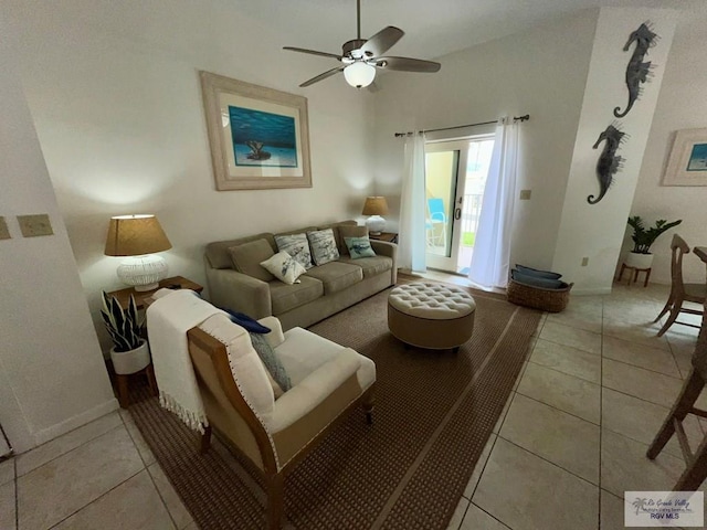 living room with baseboards, a ceiling fan, and light tile patterned floors