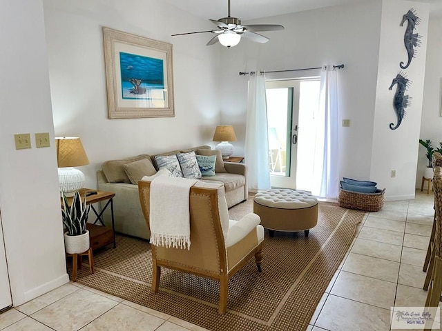 interior space featuring baseboards, a ceiling fan, and light tile patterned flooring
