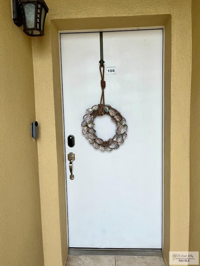 doorway to property with stucco siding