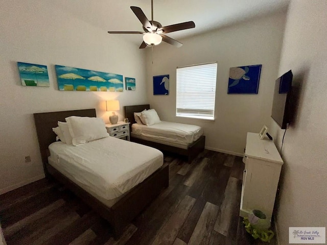 bedroom with baseboards, ceiling fan, and dark wood-type flooring