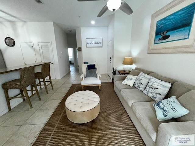 living room with ceiling fan and light tile patterned floors