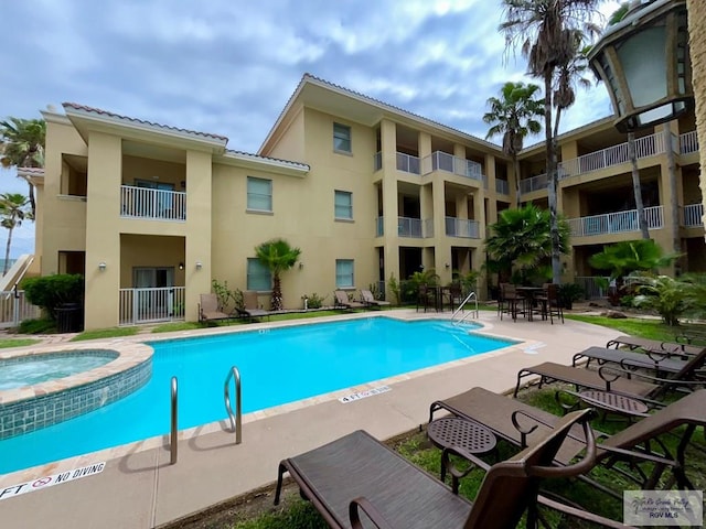 pool featuring a patio and a community hot tub