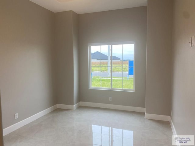 tiled spare room featuring a mountain view