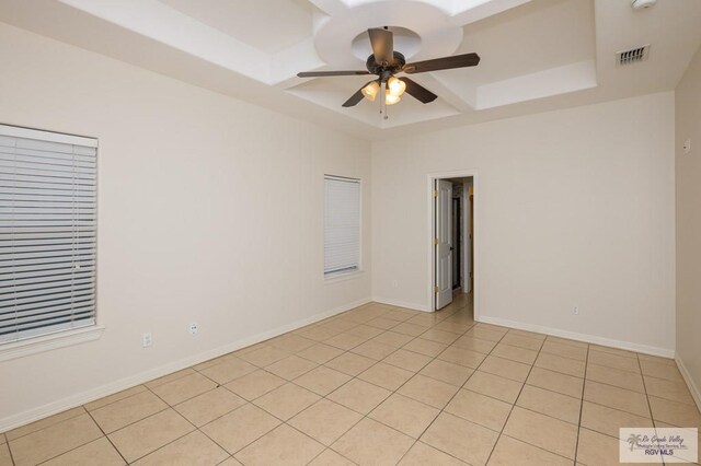 1508 W 20th St, Mission, TX 78572 - unfurnished room with a raised ceiling, a ceiling fan, light tile patterned flooring, and baseboards