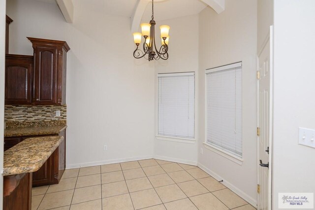 1508 W 20th St, Mission, TX 78572 - unfurnished dining area featuring a chandelier, light tile patterned floors, and baseboards