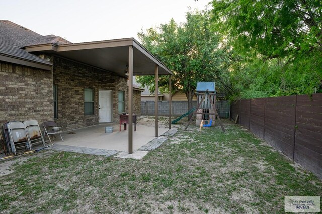 1508 W 20th St, Mission, TX 78572 - fenced backyard featuring a playground and a patio area