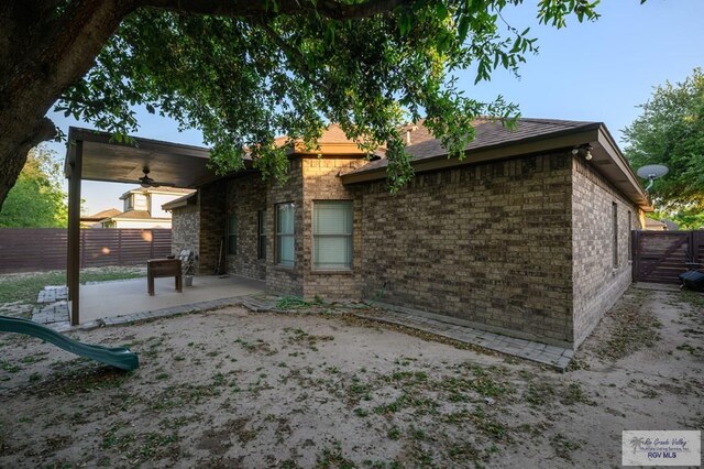 1508 W 20th St, Mission, TX 78572 - rear view of property with a ceiling fan, a patio area, fence, and brick siding