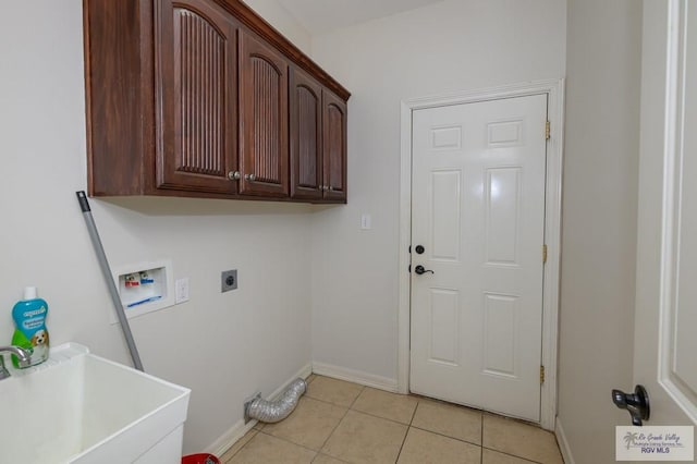 1508 W 20th St, Mission, TX 78572 - laundry area featuring hookup for an electric dryer, cabinet space, hookup for a washing machine, and baseboards