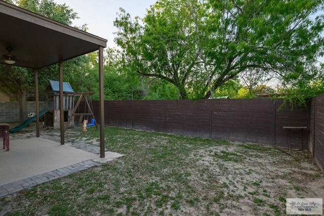 1508 W 20th St, Mission, TX 78572 - fenced backyard with a playground, a ceiling fan, and a patio