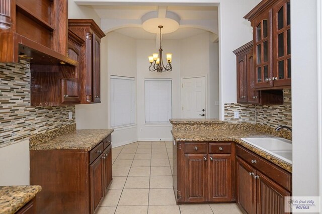 1508 W 20th St, Mission, TX 78572 - kitchen featuring a sink, a chandelier, decorative backsplash, and light tile patterned floors