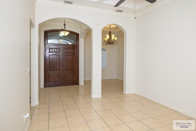 1508 W 20th St, Mission, TX 78572 - foyer entrance with a chandelier, crown molding, arched walkways, ceiling fan, and light tile patterned flooring