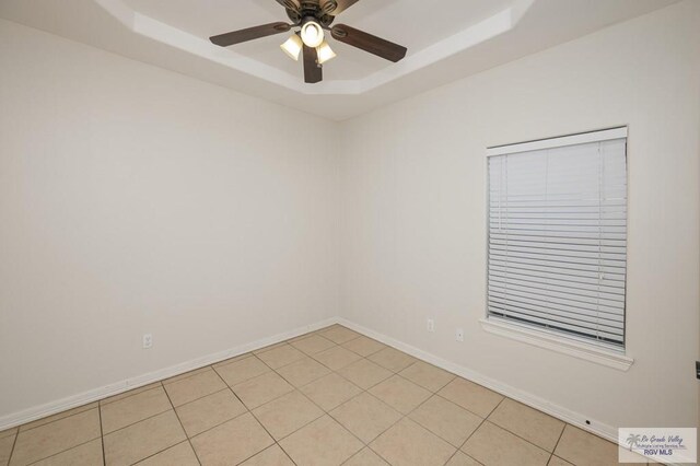 1508 W 20th St, Mission, TX 78572 - unfurnished room with a raised ceiling, a ceiling fan, and baseboards
