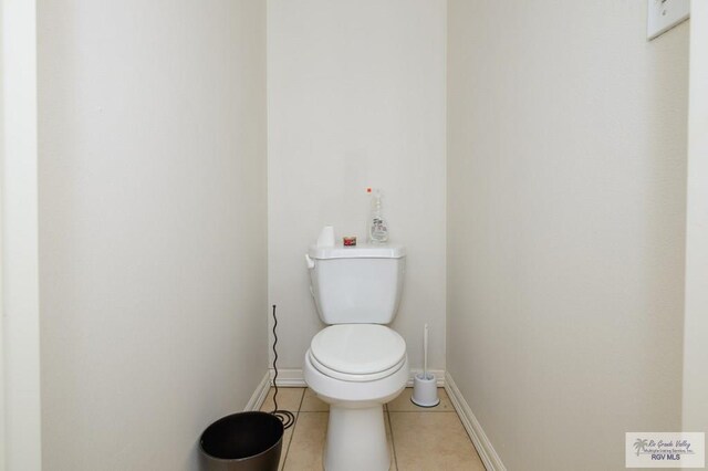 1508 W 20th St, Mission, TX 78572 - bathroom featuring tile patterned flooring, baseboards, and toilet