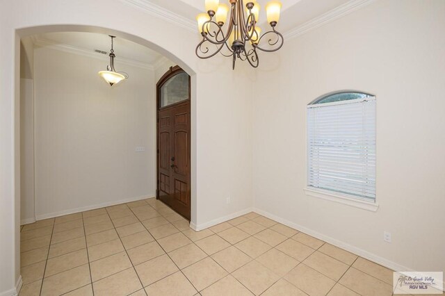 1508 W 20th St, Mission, TX 78572 - spare room featuring ornamental molding, arched walkways, a chandelier, light tile patterned floors, and baseboards