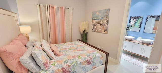 bedroom featuring sink and light tile patterned flooring