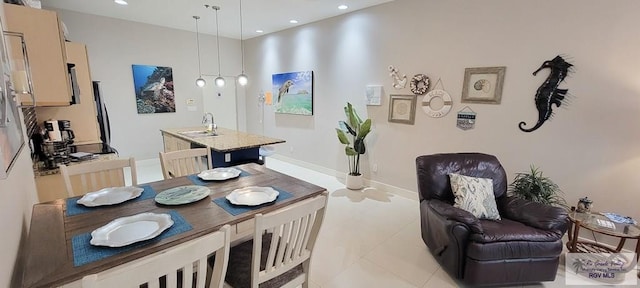 dining room with light tile patterned floors and sink