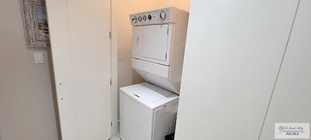 laundry room with stacked washer and dryer