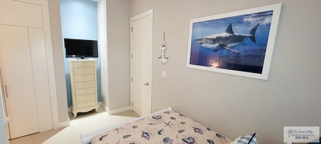 bedroom with light tile patterned floors