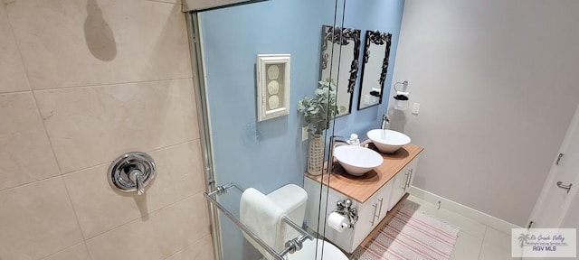 bathroom with tiled shower and vanity