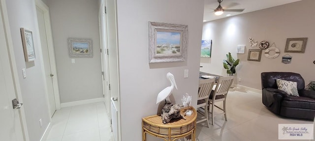 interior space featuring ceiling fan and light tile patterned floors