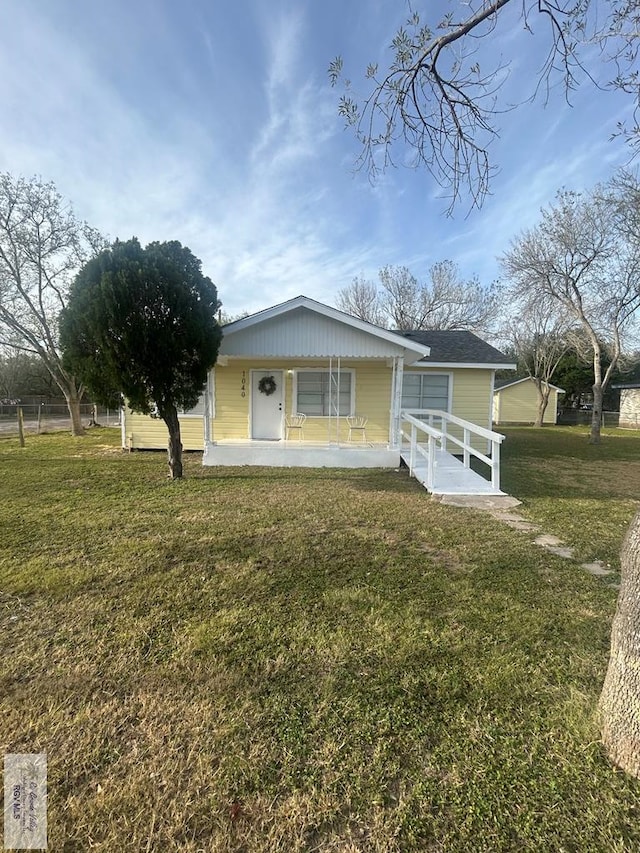 view of front of property with a porch and a front yard