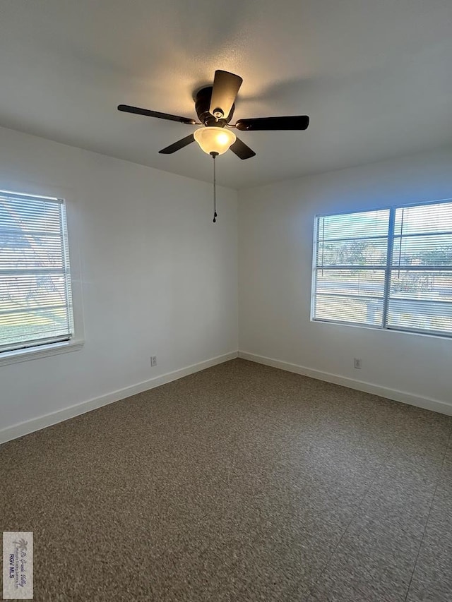 empty room with a healthy amount of sunlight and ceiling fan