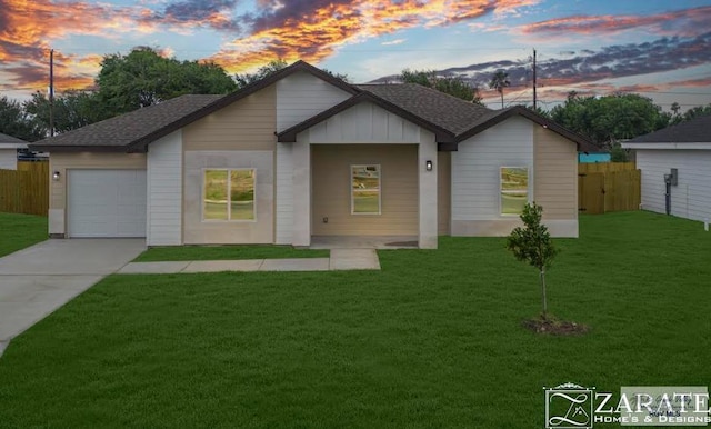 ranch-style house with a garage and a lawn