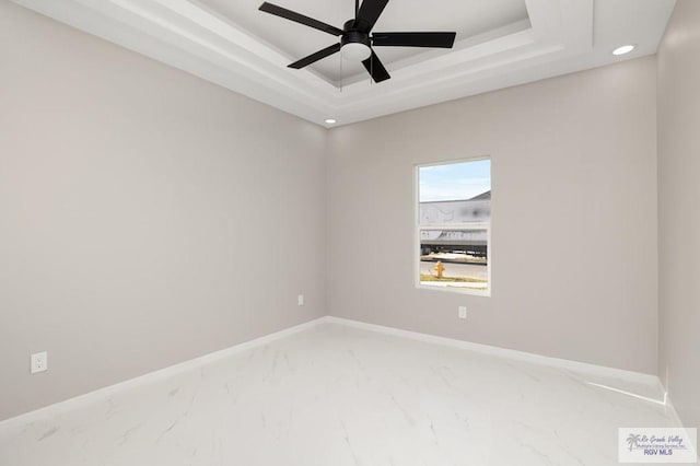 1202 Moses Dr, San Juan, TX 78589 - unfurnished room with a raised ceiling, baseboards, recessed lighting, and marble finish floor