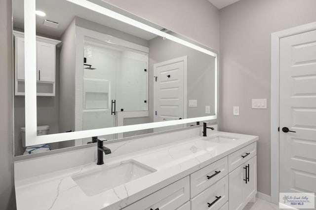 1202 Moses Dr, San Juan, TX 78589 - full bath with double vanity, a sink, and a stall shower