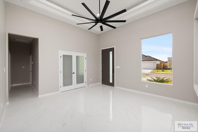 1202 Moses Dr, San Juan, TX 78589 - spare room with baseboards, a ceiling fan, french doors, and marble finish floor