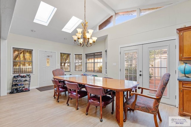 dining room with french doors, light wood-type flooring, an inviting chandelier, and vaulted ceiling with beams