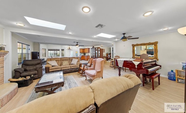 living room featuring ceiling fan, light hardwood / wood-style flooring, and crown molding