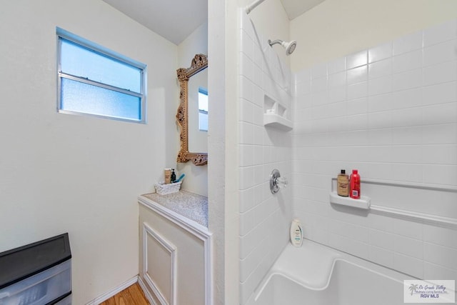 bathroom featuring hardwood / wood-style flooring and tub / shower combination