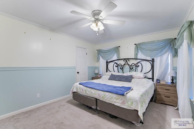 carpeted bedroom with ceiling fan and crown molding