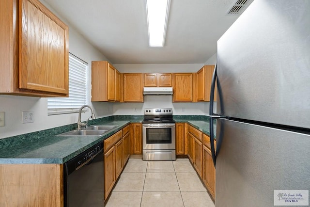 kitchen with light tile patterned floors, stainless steel appliances, and sink