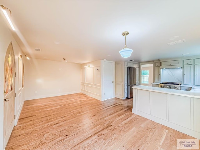 1214 W Lincoln Ave Unit 22, Harlingen, TX 78550 - kitchen with freestanding refrigerator, range, light wood-style floors, and light countertops