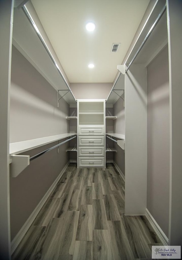 walk in closet featuring dark wood-style floors and visible vents