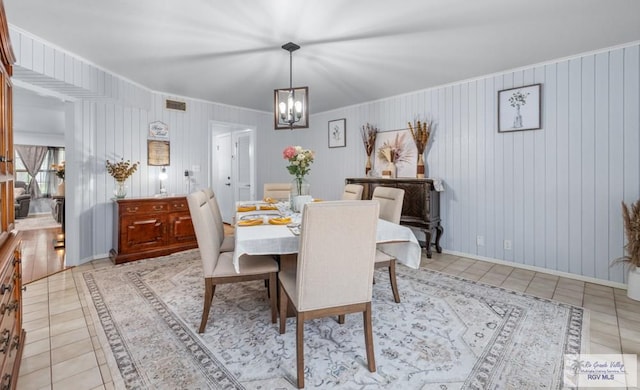 5503 Brazo Cir, Harlingen, TX 78552 - dining area featuring light tile patterned flooring, a chandelier, baseboards, and crown molding