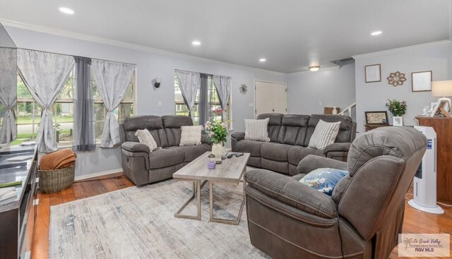 5503 Brazo Cir, Harlingen, TX 78552 - living area featuring wood finished floors, crown molding, stairway, and recessed lighting