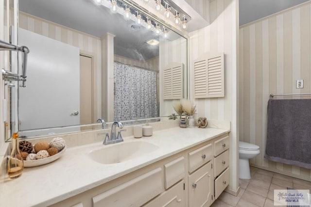 5503 Brazo Cir, Harlingen, TX 78552 - bathroom with wallpapered walls, tile patterned floors, toilet, and vanity