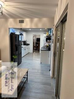 hallway with hardwood / wood-style flooring