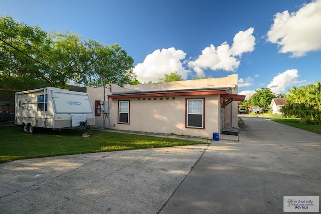 view of property exterior with a yard