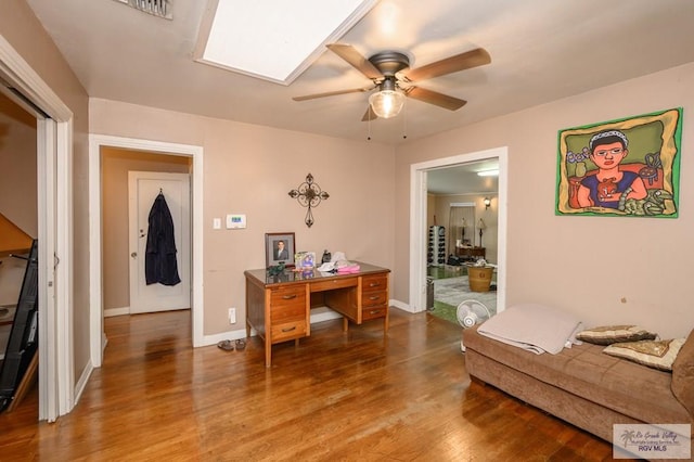 home office with hardwood / wood-style floors and ceiling fan