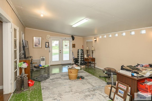 interior space featuring vaulted ceiling, ornamental molding, and french doors