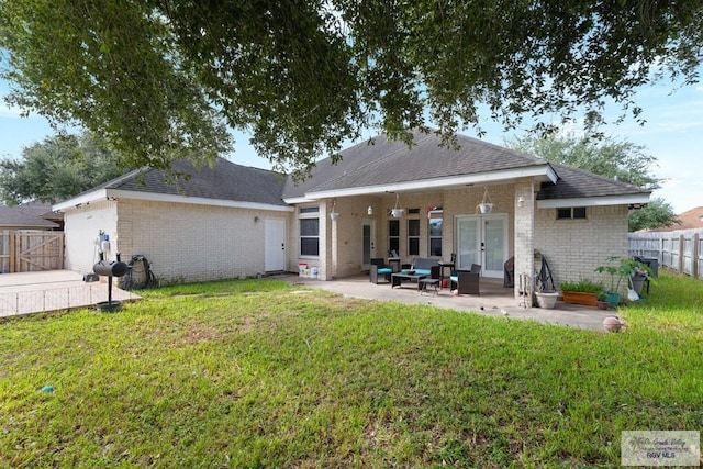 back of house with a lawn, a patio area, and an outdoor hangout area