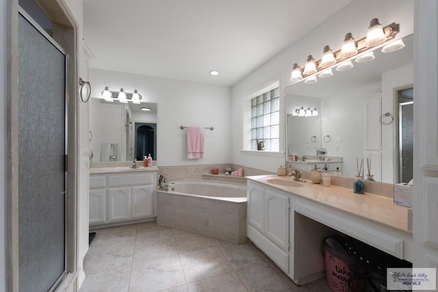 bathroom featuring vanity and separate shower and tub