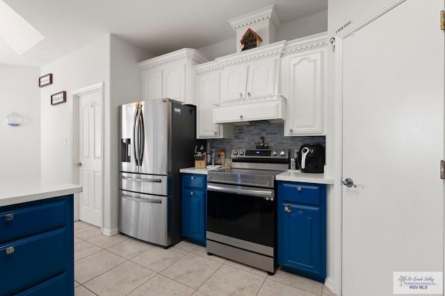 kitchen featuring custom exhaust hood, decorative backsplash, blue cabinetry, appliances with stainless steel finishes, and white cabinetry